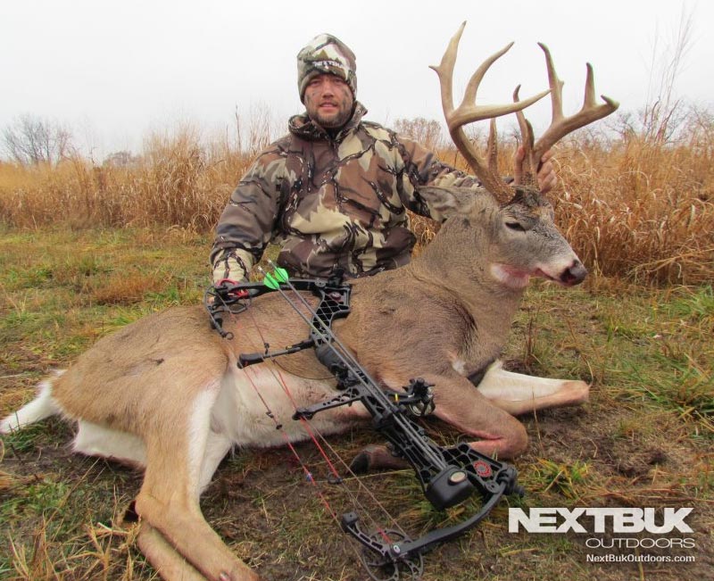 Pro staffer Justin Hollandsworth with big 8pt whitetail archery kill buck